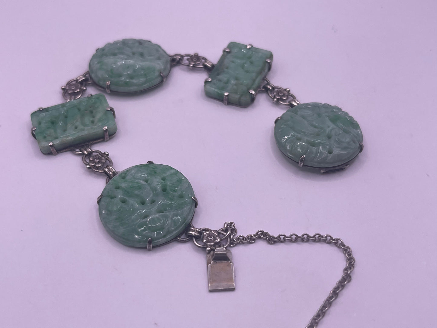 A silver bracelet with jade plaques