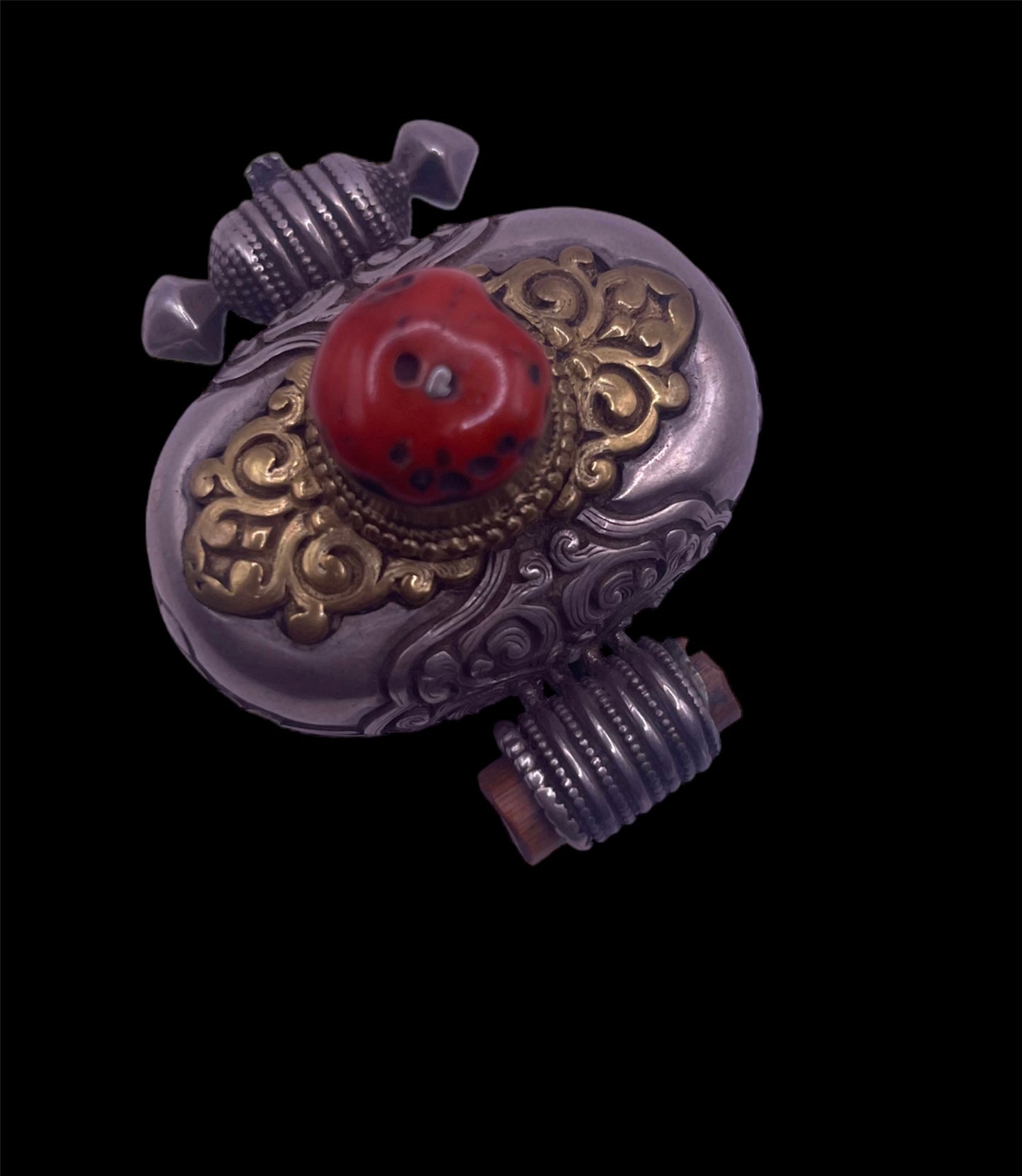 An antique silver and coral ghau amulet