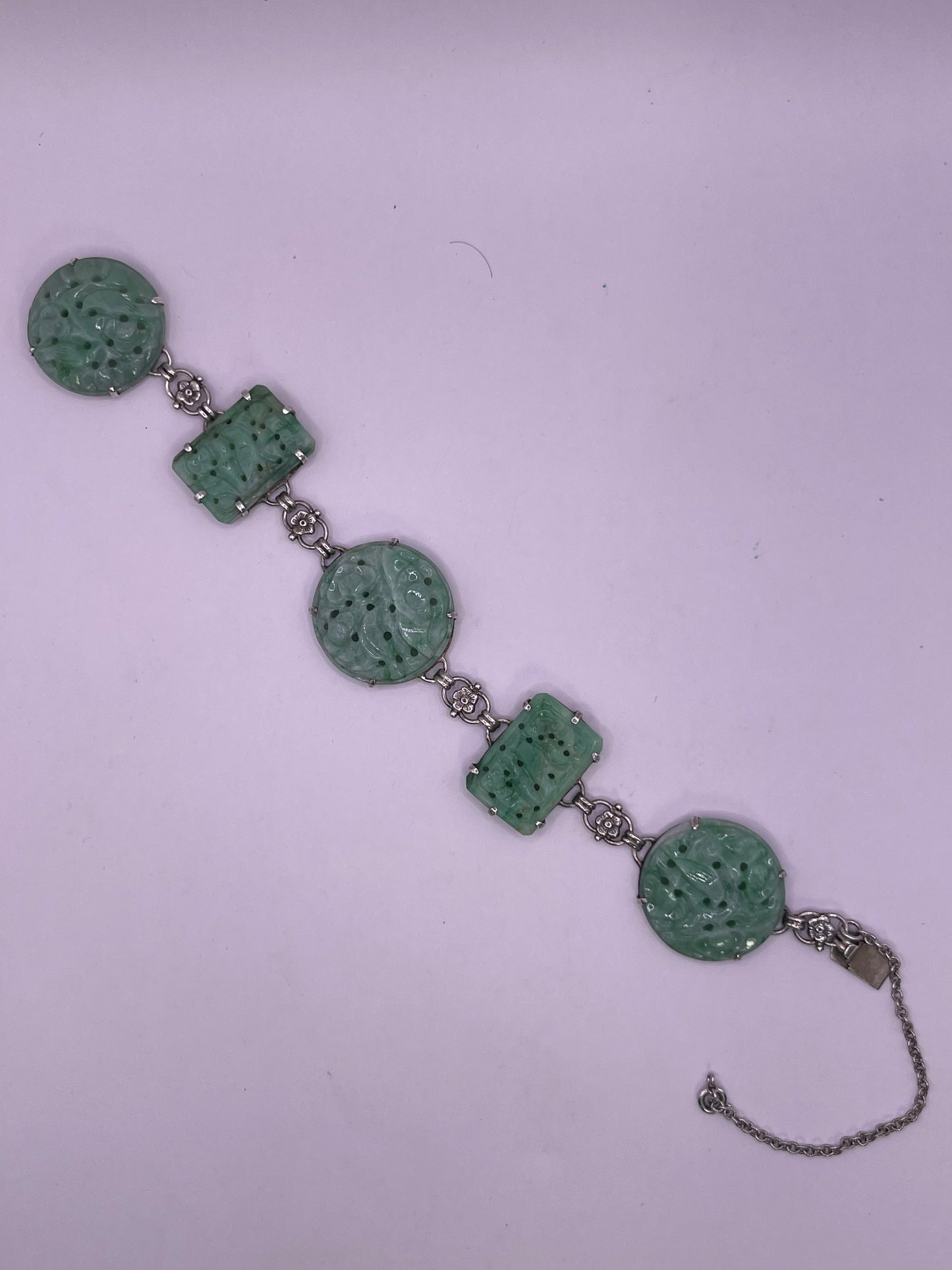 A silver bracelet with jade plaques