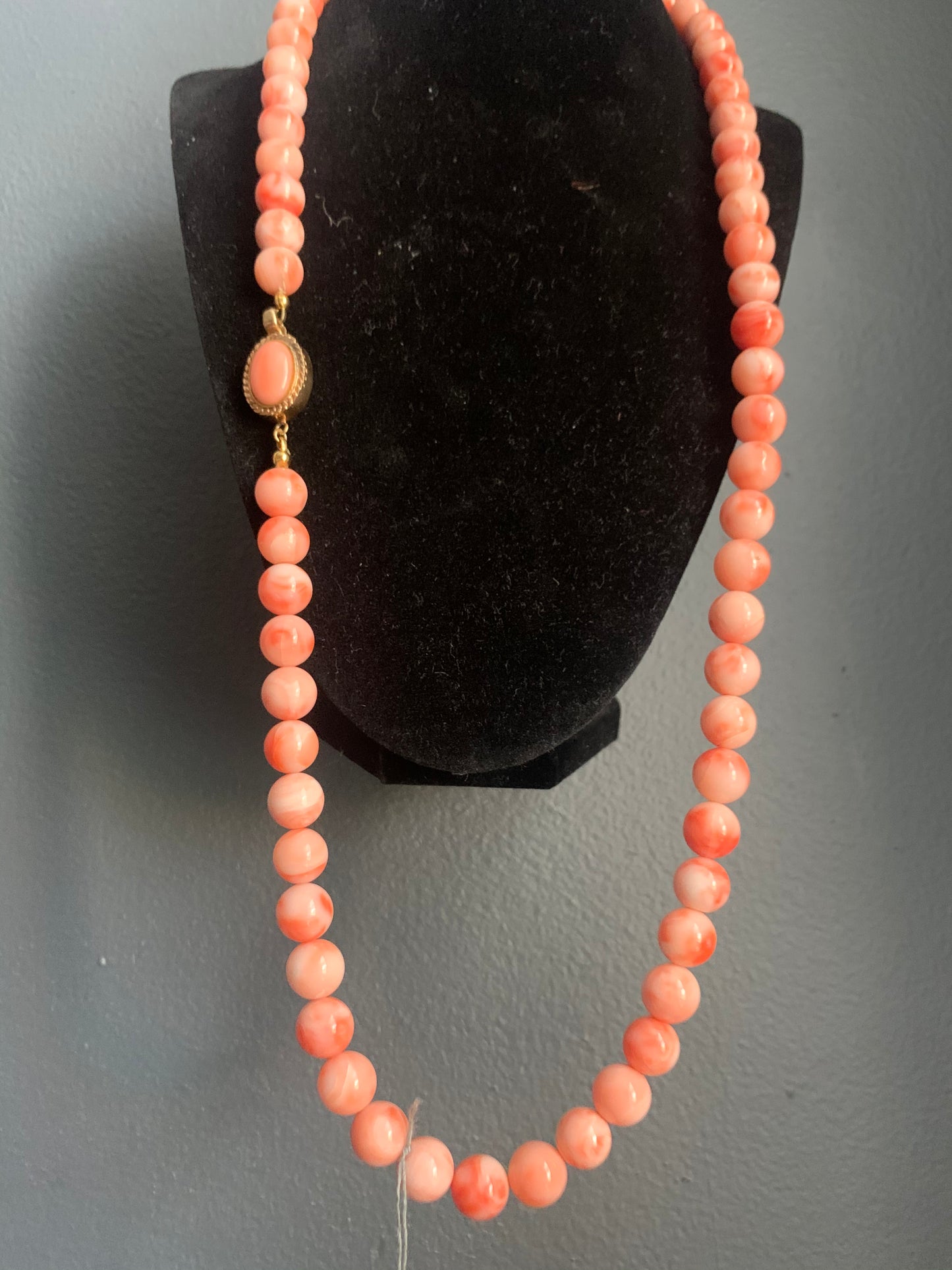 A salmon colored coral -like bead necklace