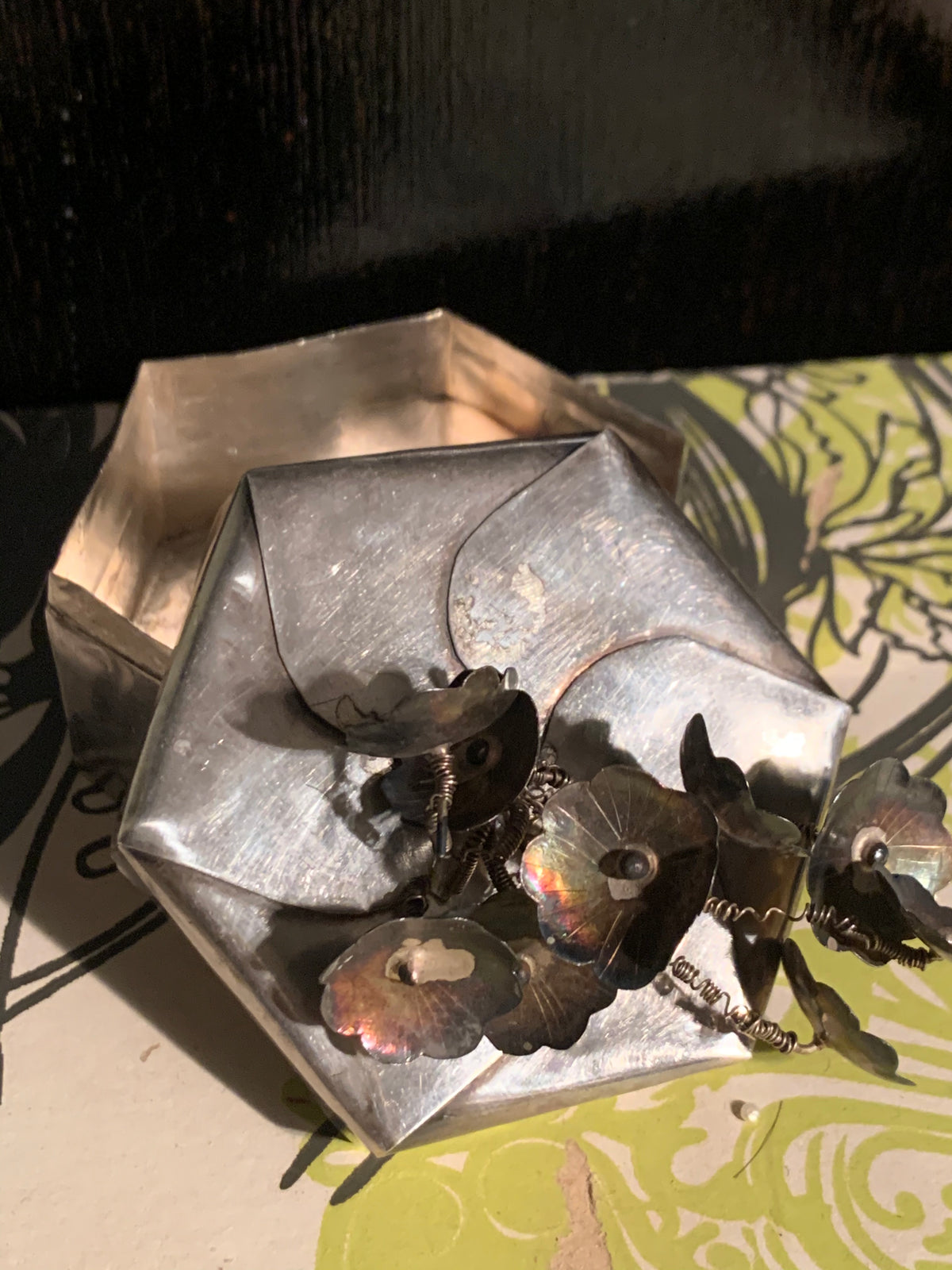 A hexagonal silver box with lid