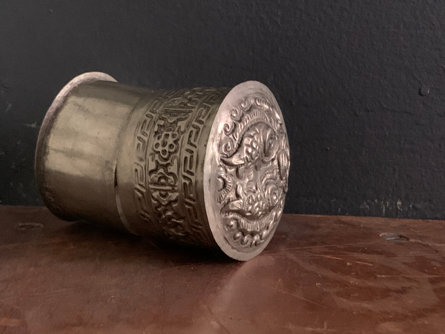 A cylindrical silver box