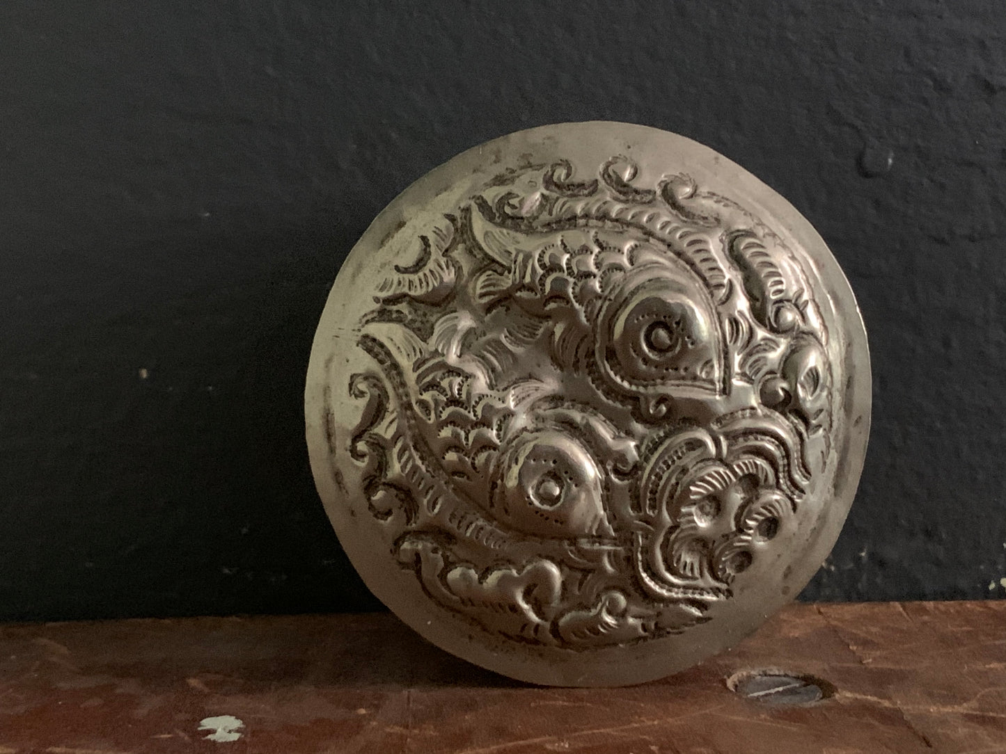 A cylindrical silver box