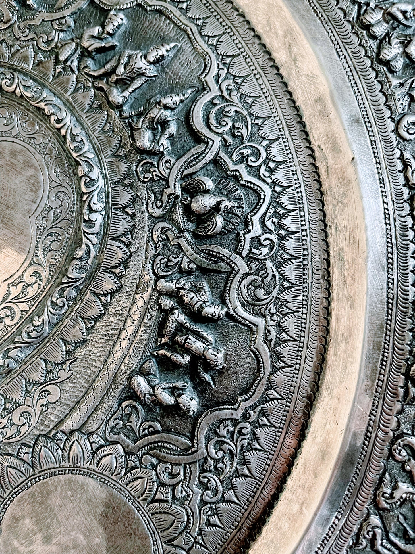 A Burmese antique elaborately carved circular tray and oval shaped jug with a pointed mug.