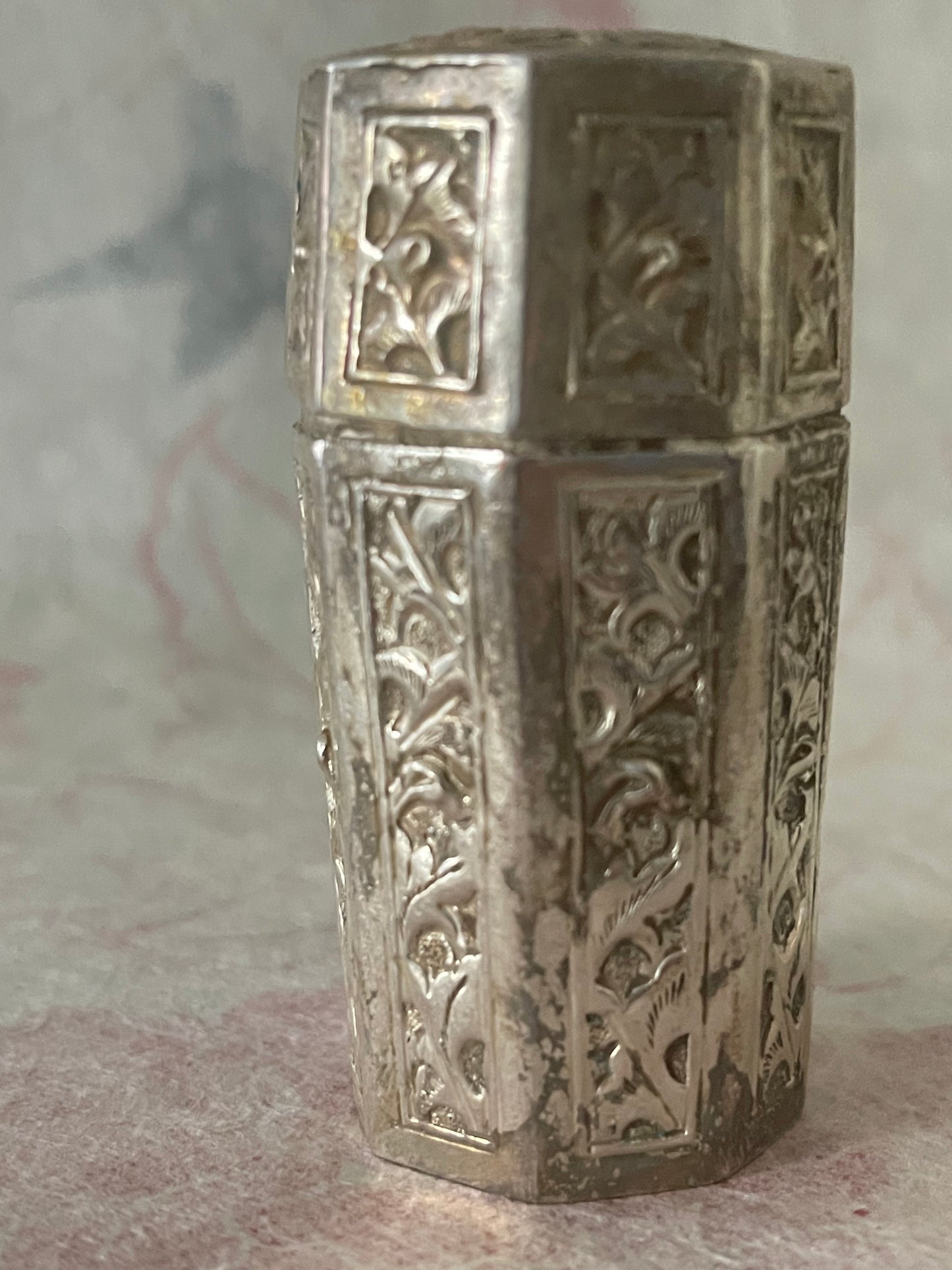 An antique octagonal shaped silver box with lid from south east Asia.