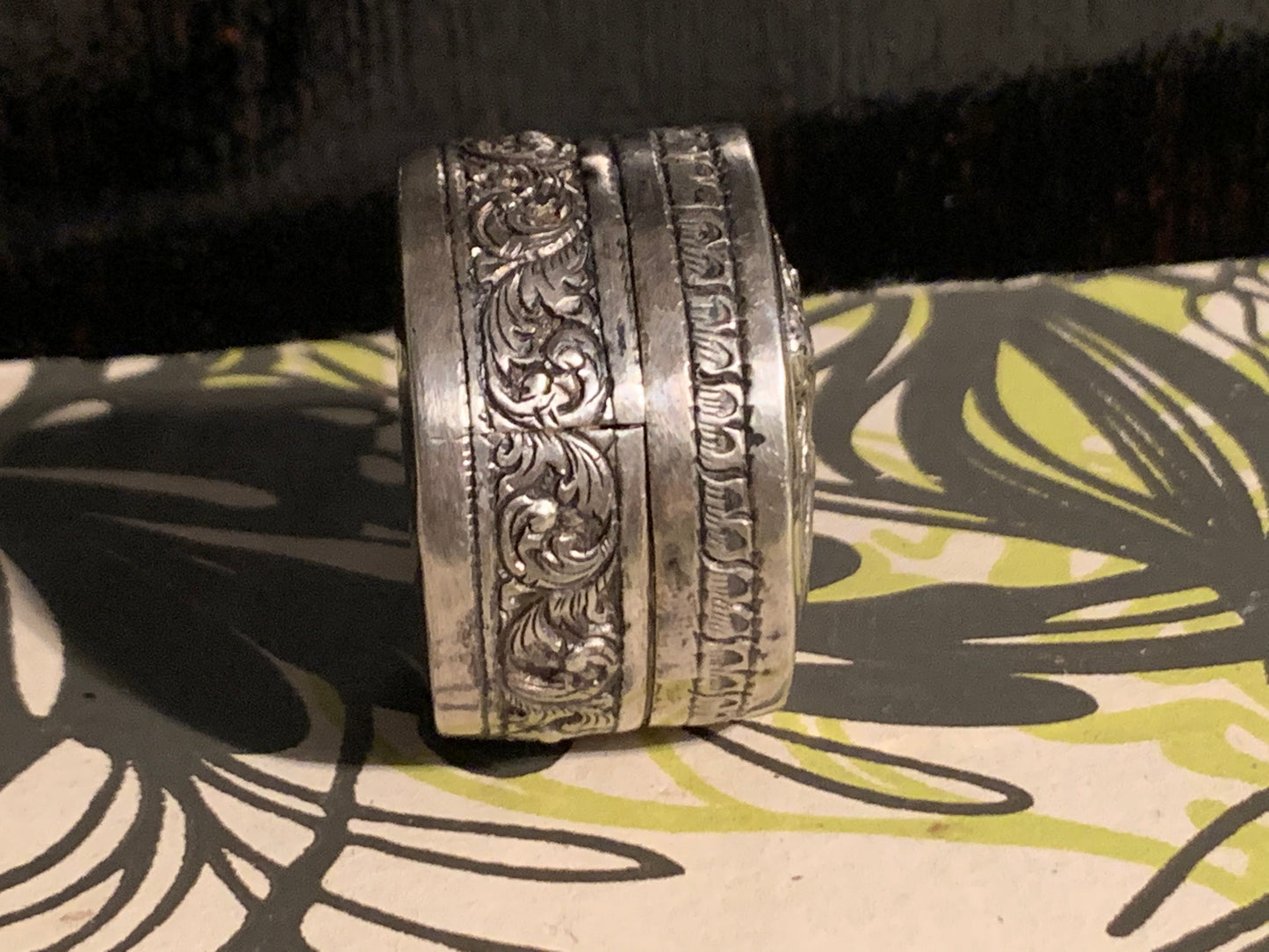 A small silver pill box