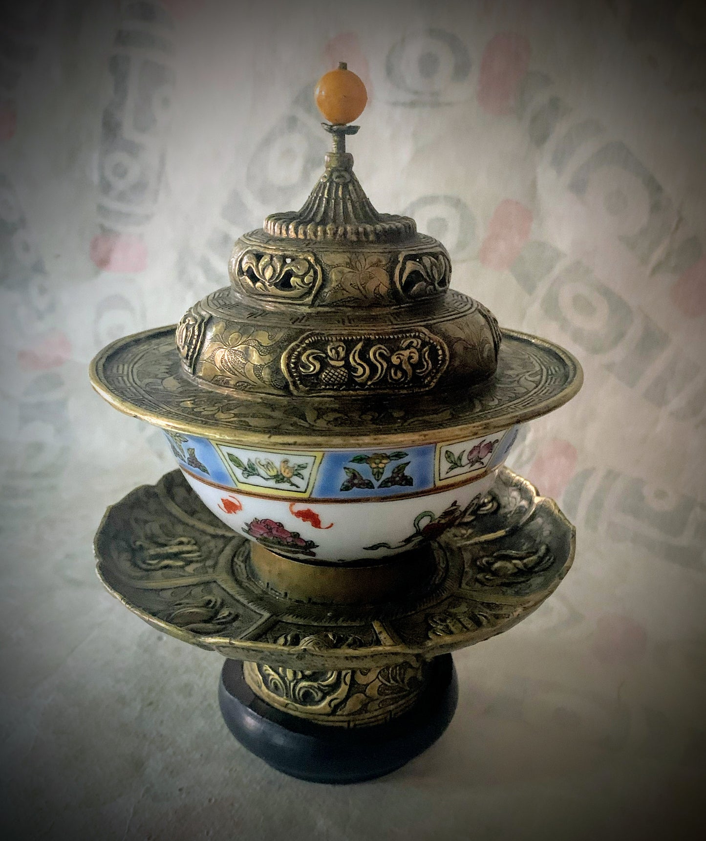 An antique metal cup stand