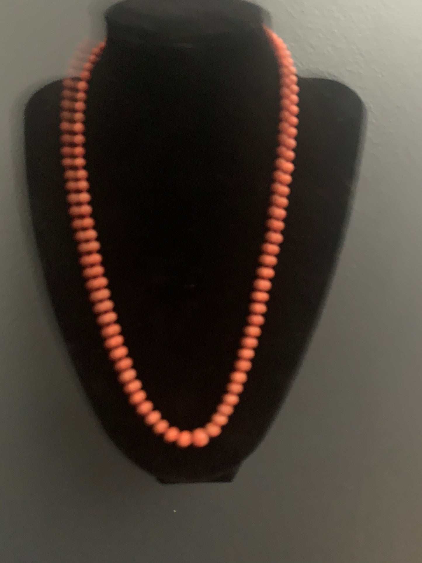 A coral necklace with a carved coral pendant