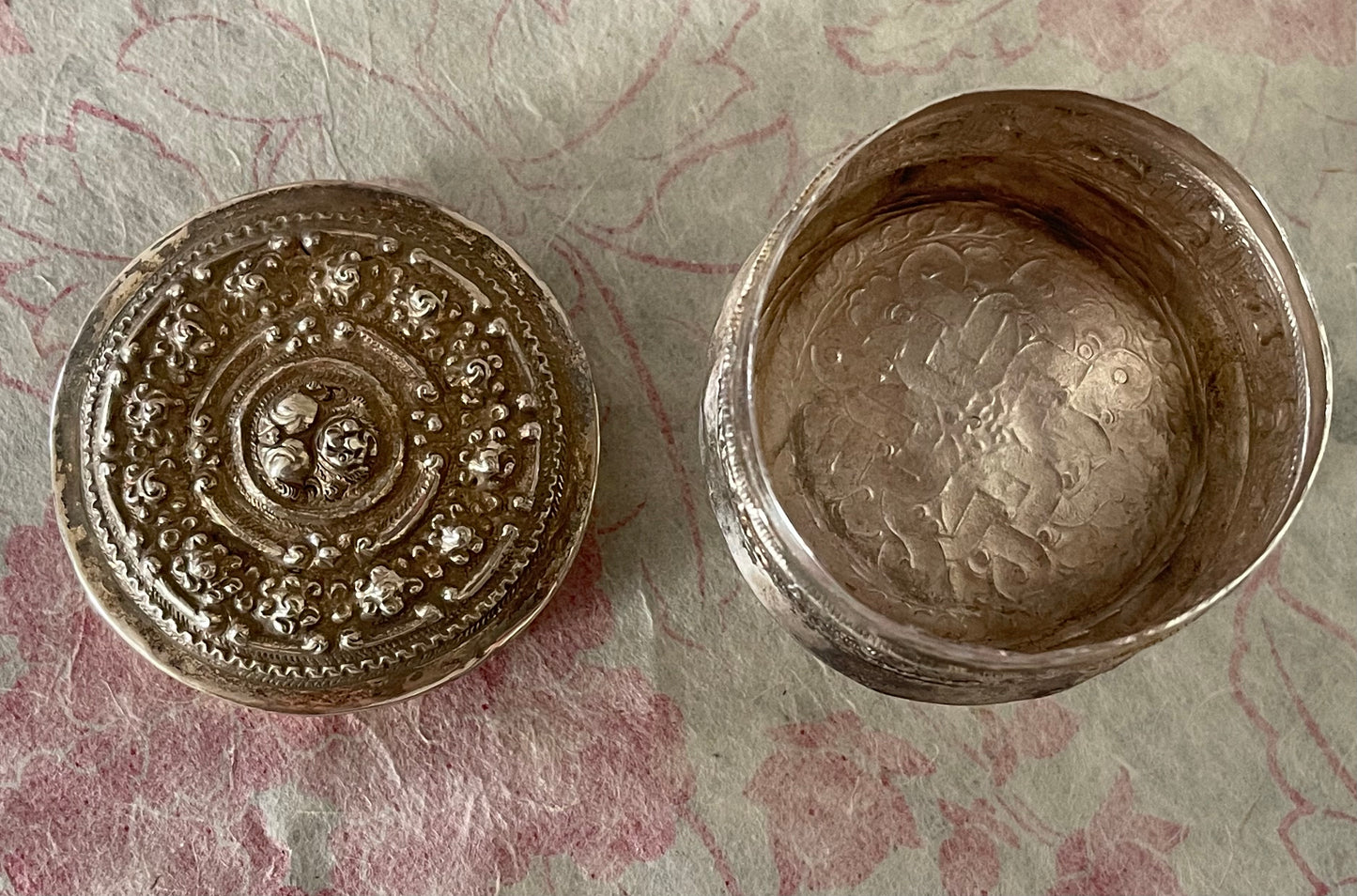 An antique silver south East Asian round box with lid