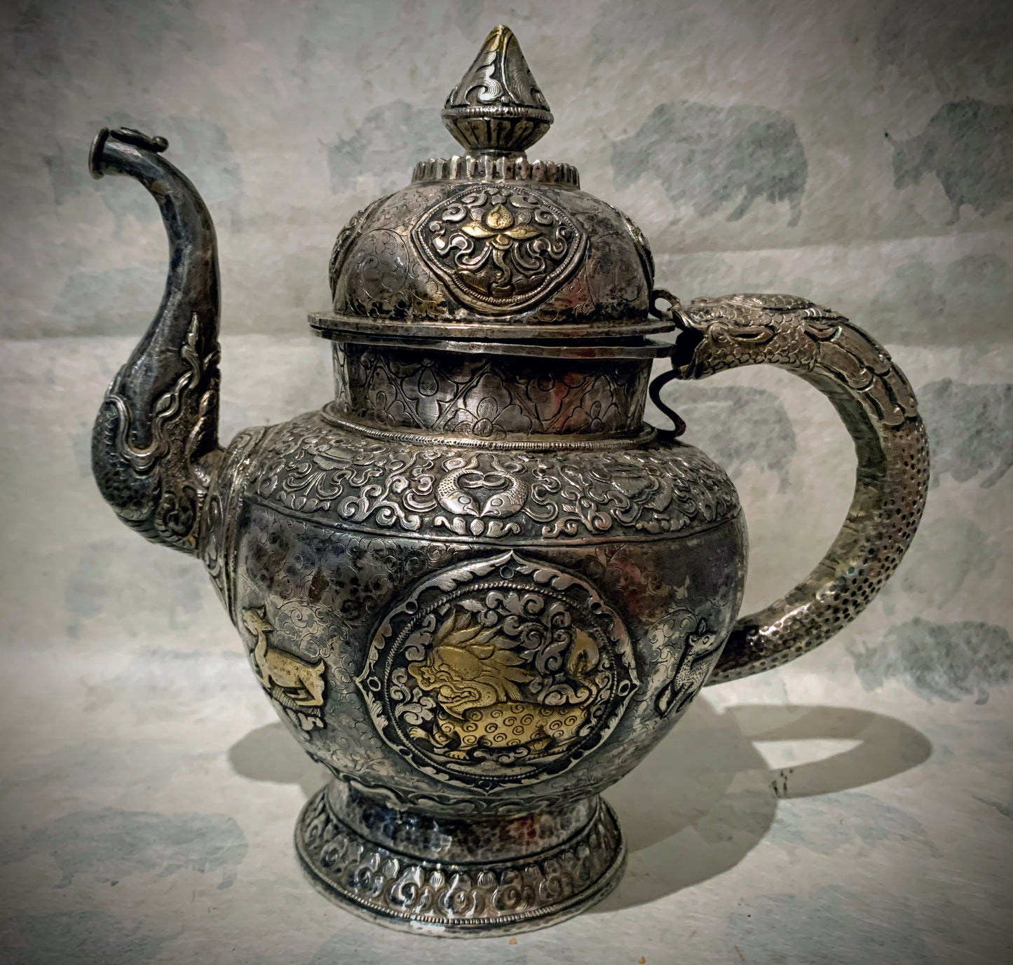 An antique silver and gilt ceremonial Tibetan teapot