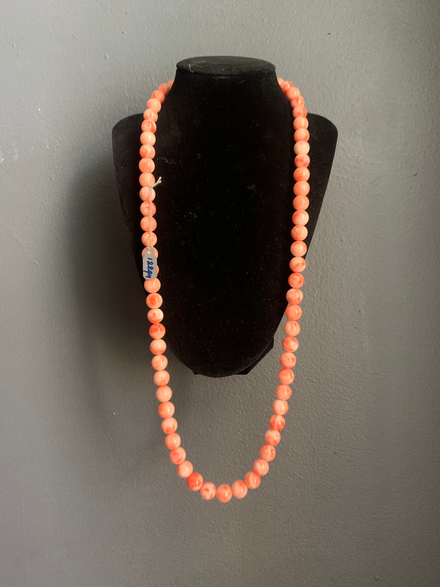 A salmon colored coral -like bead necklace