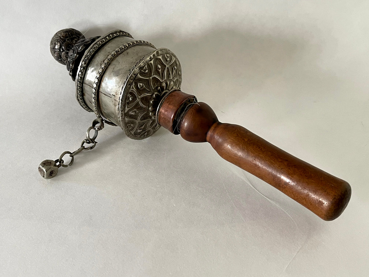 An original handmade vintage Tibetan silver handheld prayer wheel simply carved and decorated