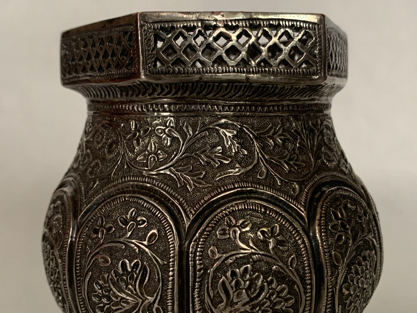 An exquisitely carved antique silver utensil -possibly a censer with floral details