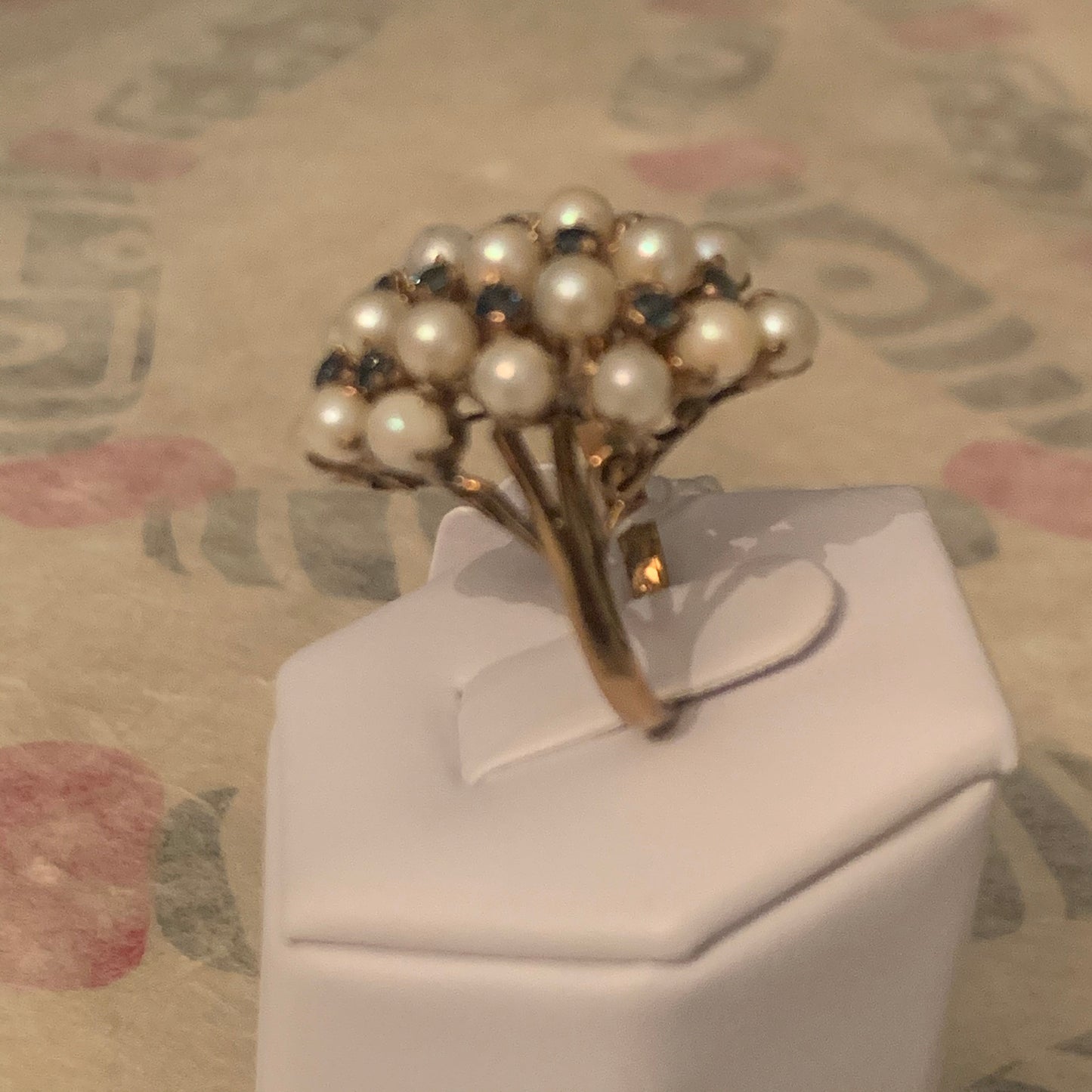 A pearl and sapphire ring in a 14kt setting