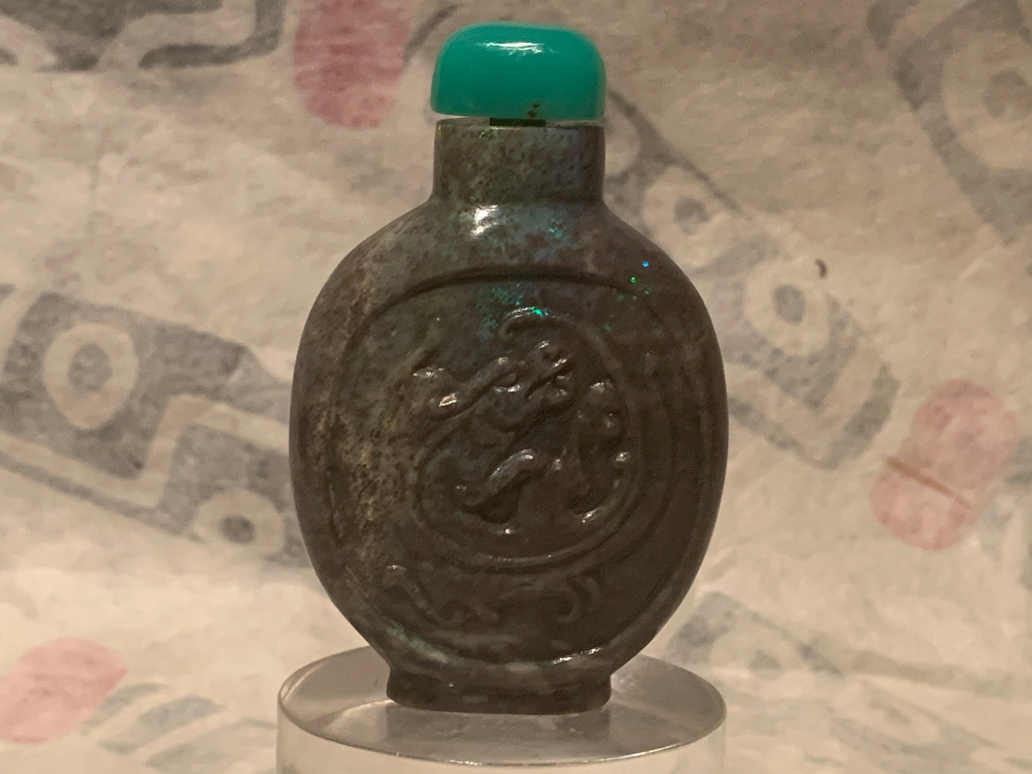 A carved opal snuff bottle with a jade stopper