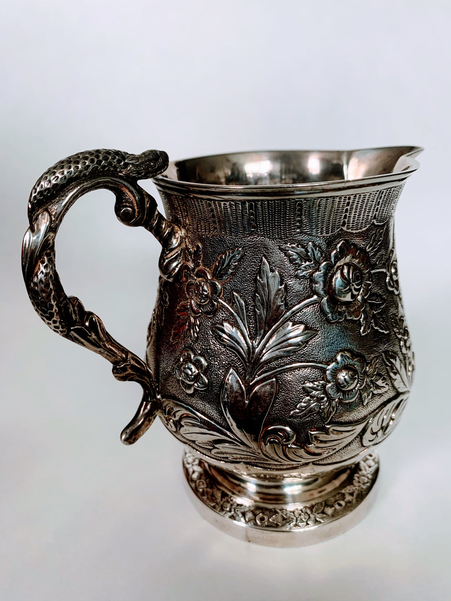 A silver creamer (roses)