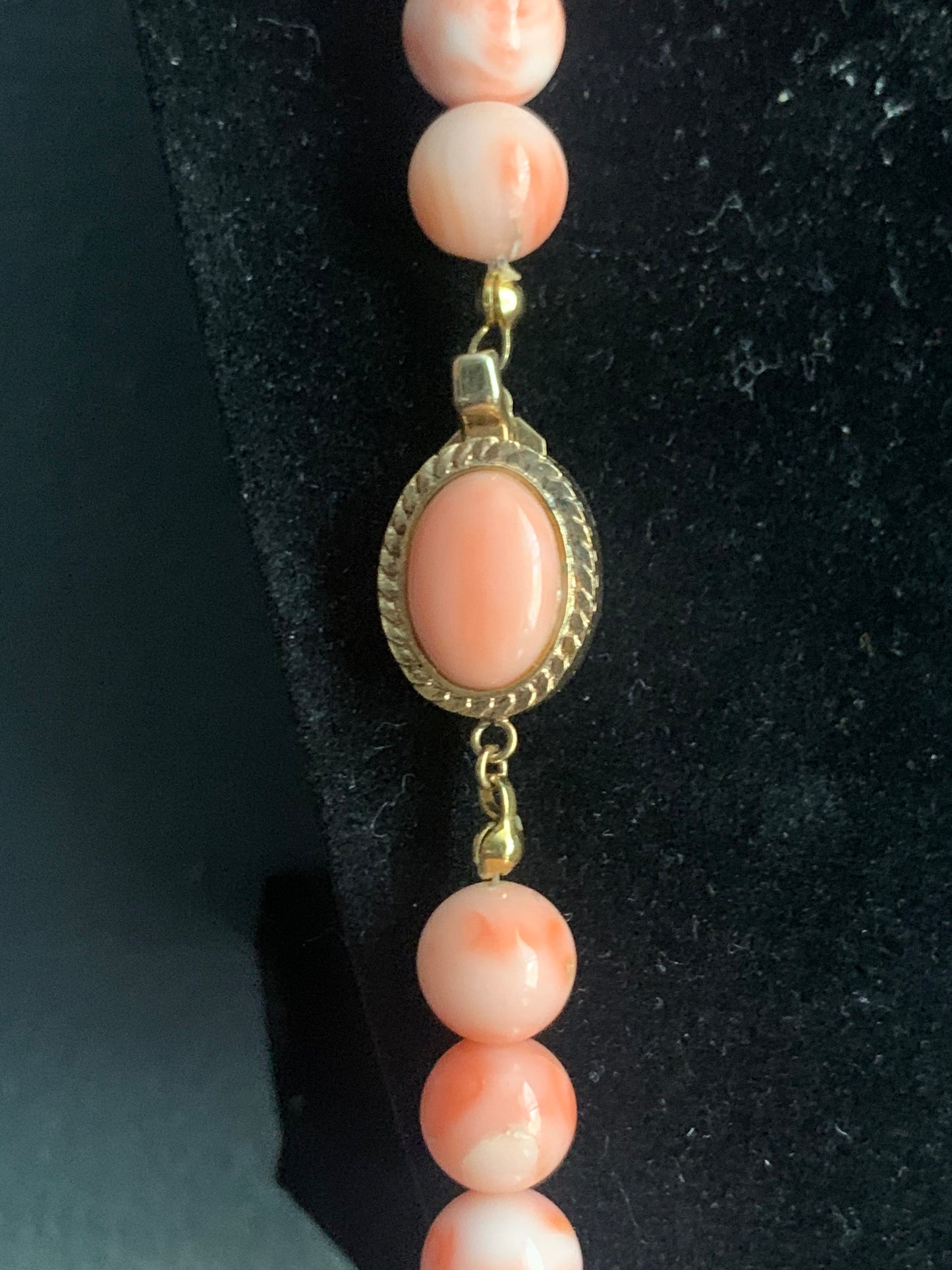 A salmon colored coral -like bead necklace