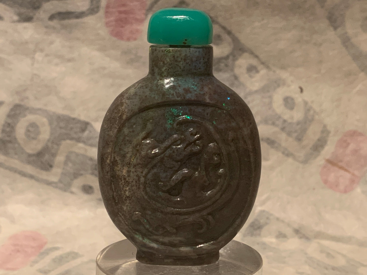 A carved opal snuff bottle with a jade stopper