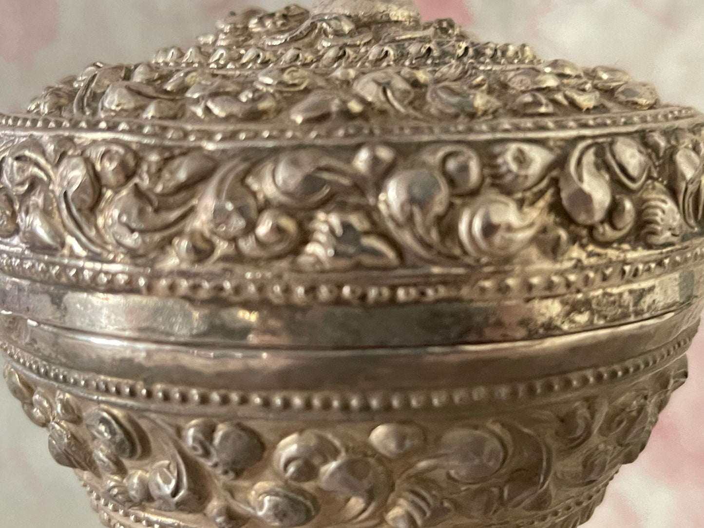 An antique silver south East Asian round box with lid