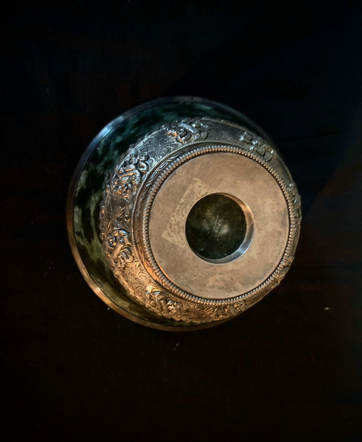 A jade bowl with silver details