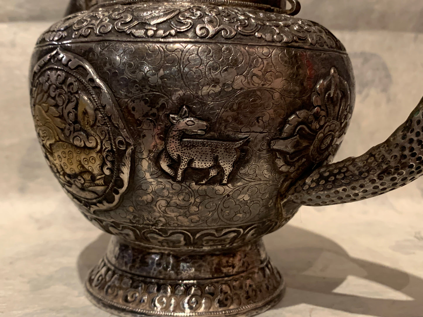 An antique silver and gilt ceremonial Tibetan teapot