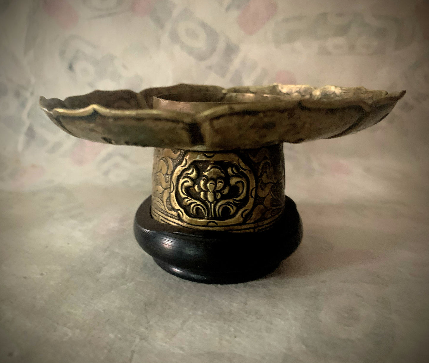 An antique metal cup stand