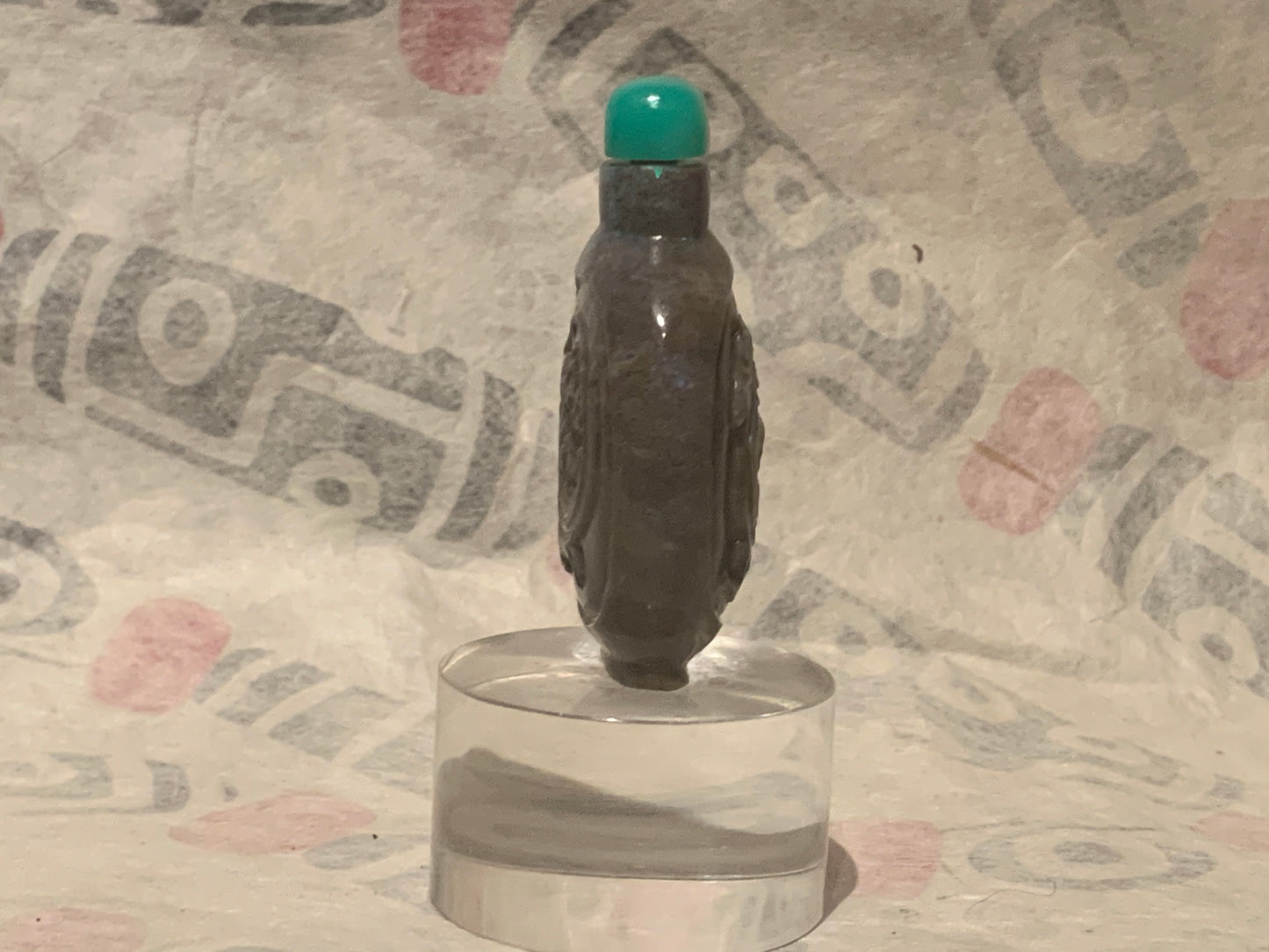 A carved opal snuff bottle with a jade stopper