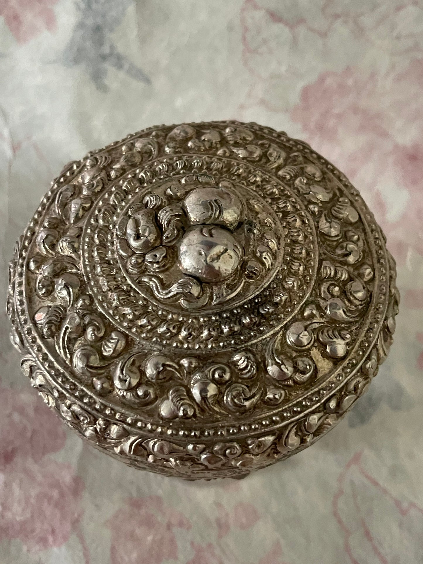 An antique silver south East Asian round box with lid