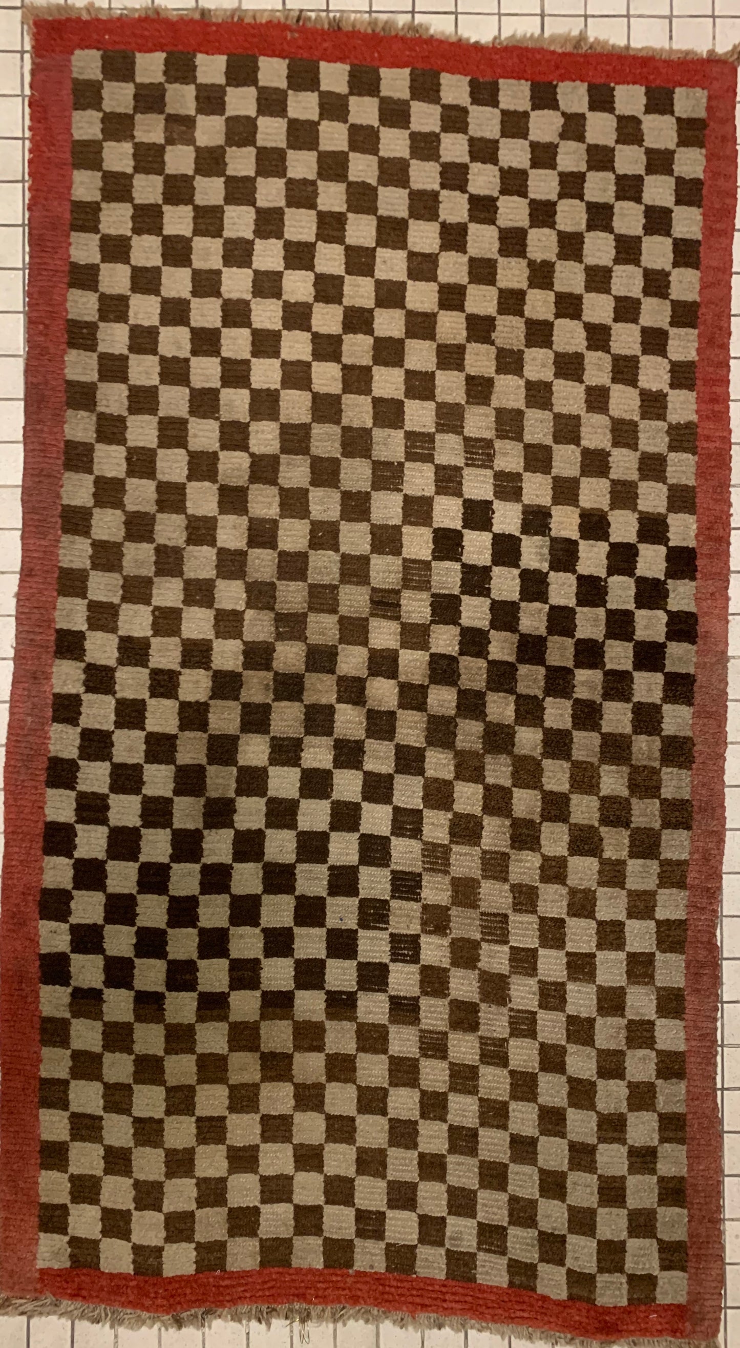 An antique Tibetan checkerboard rug