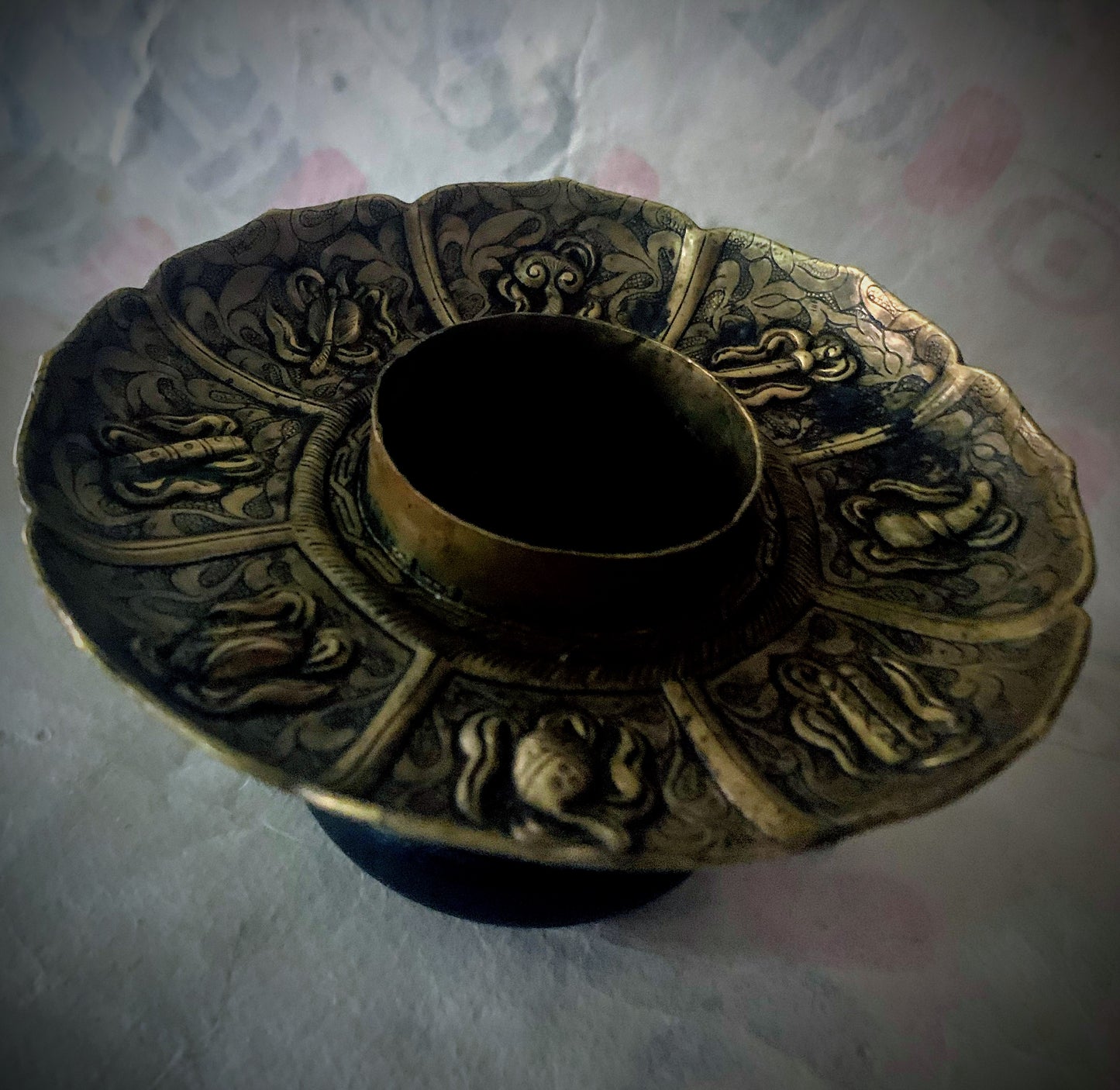 An antique metal cup stand