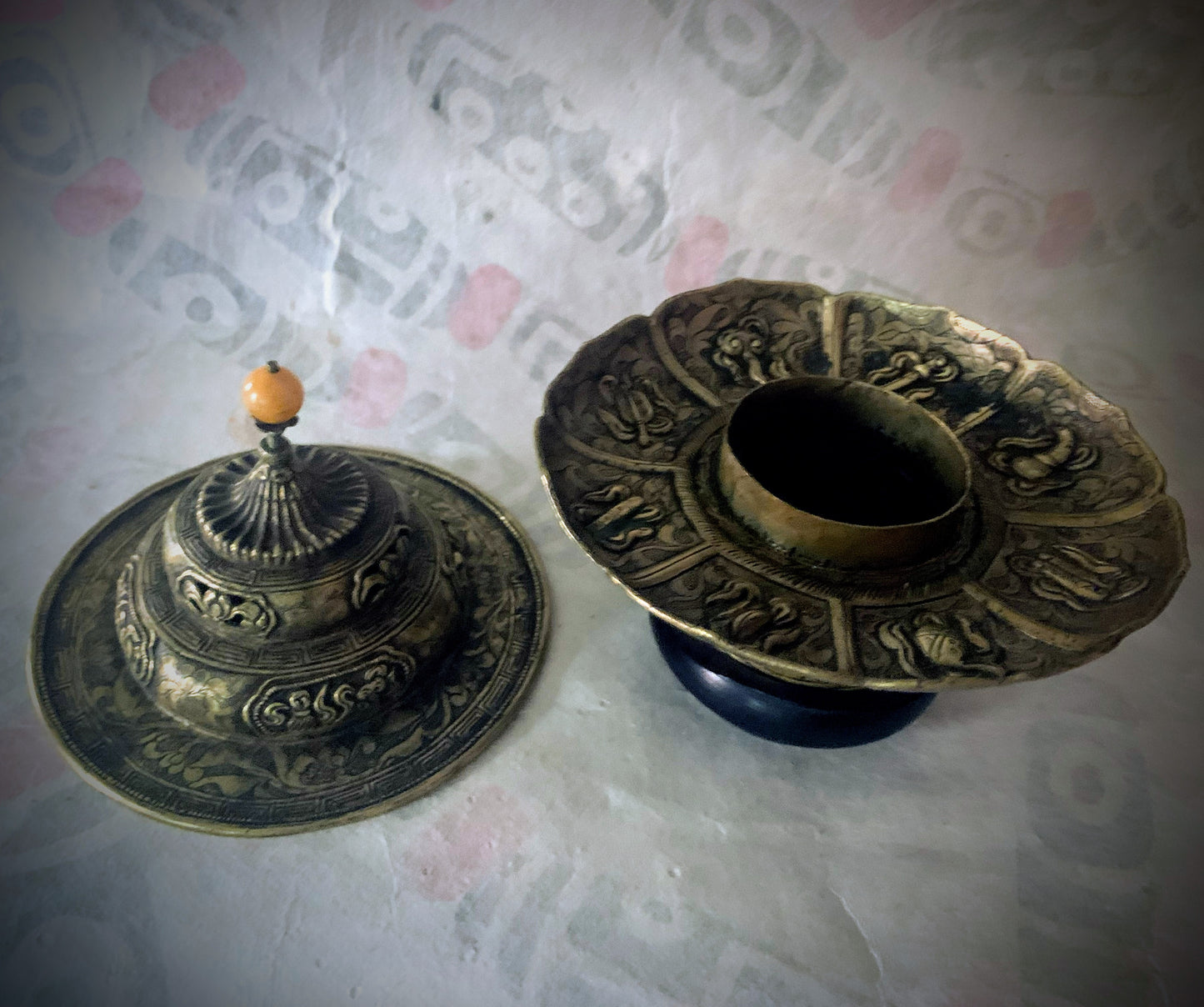 An antique metal cup stand