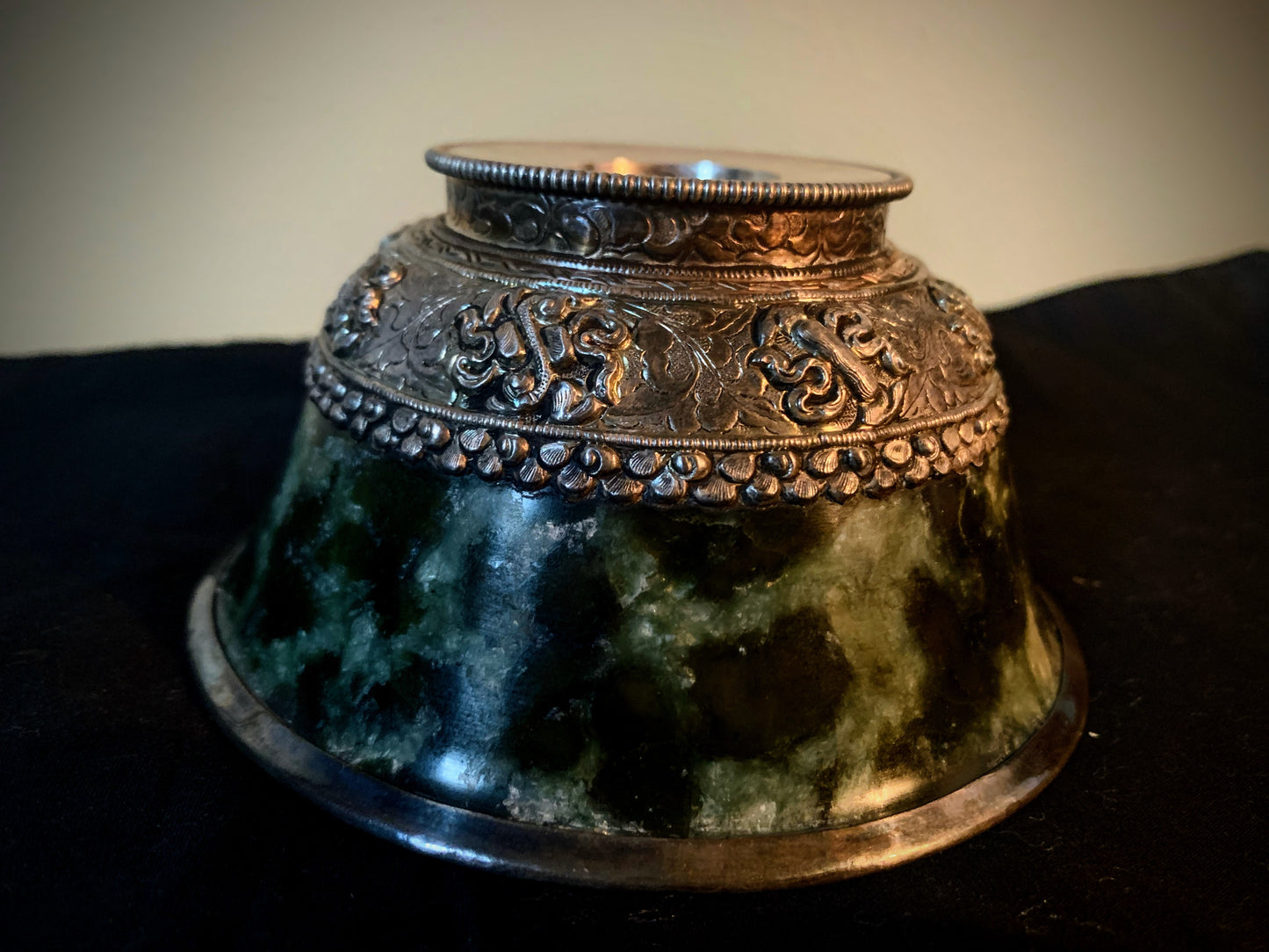 A jade bowl with silver details