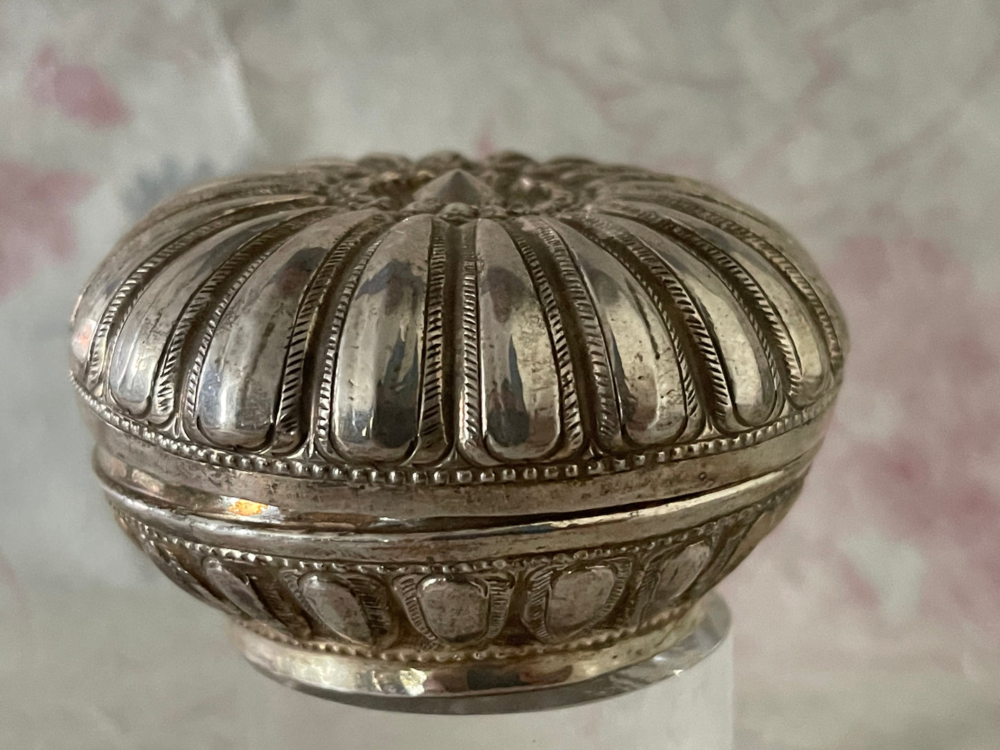 An antique silver south East Asian round box with lid