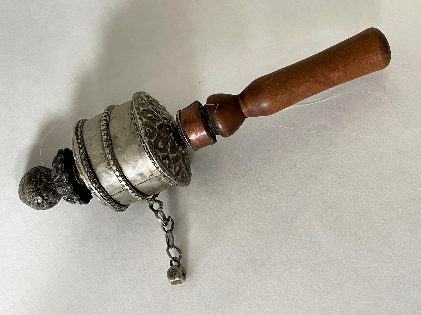An original handmade vintage Tibetan silver handheld prayer wheel simply carved and decorated