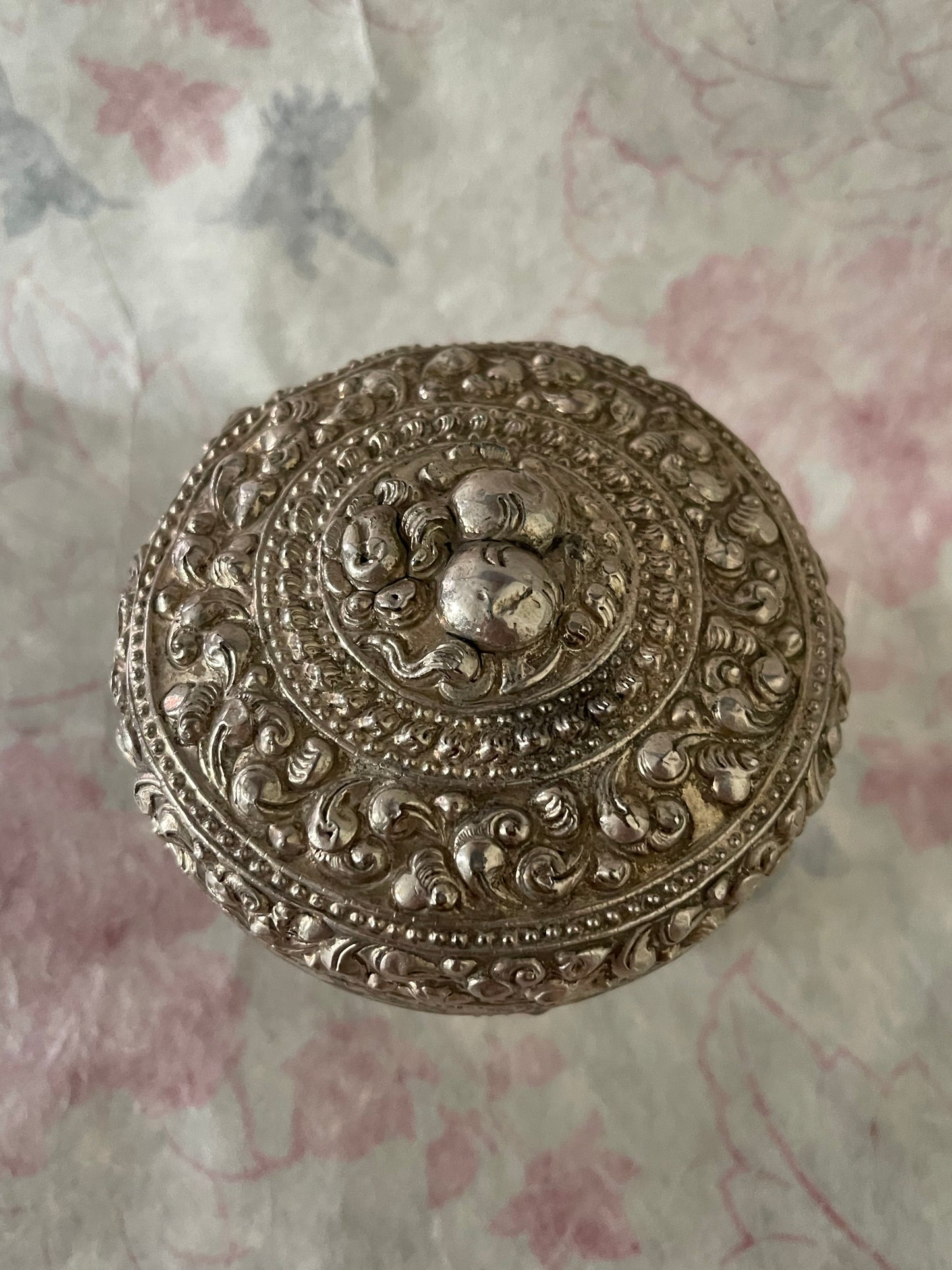 An antique silver south East Asian round box with lid