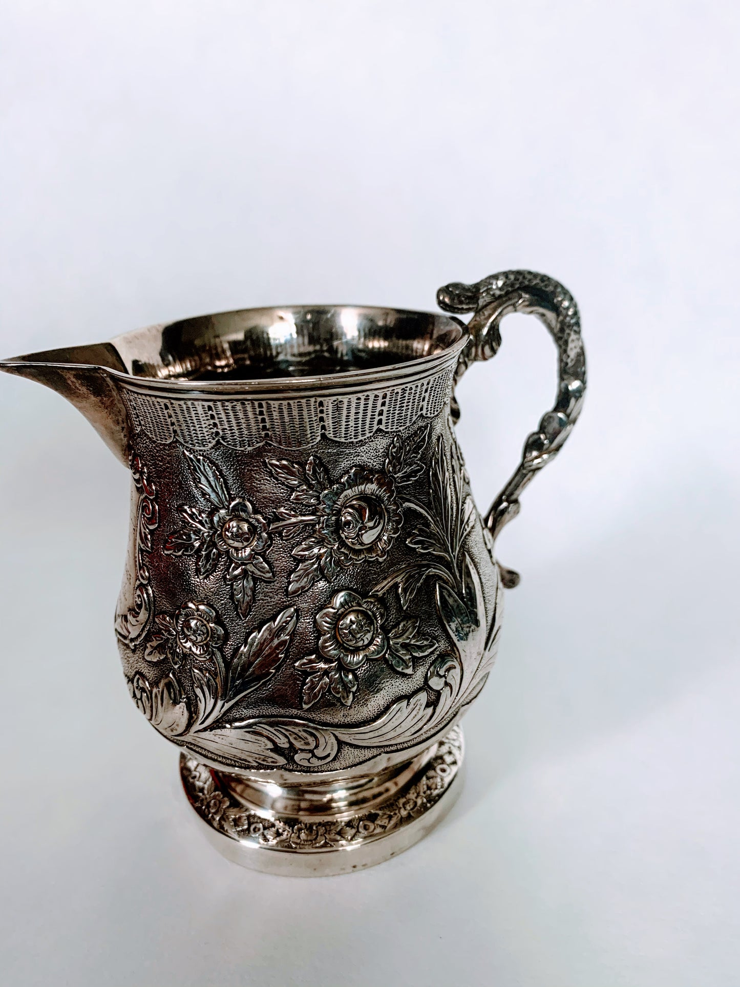 A silver creamer (roses)