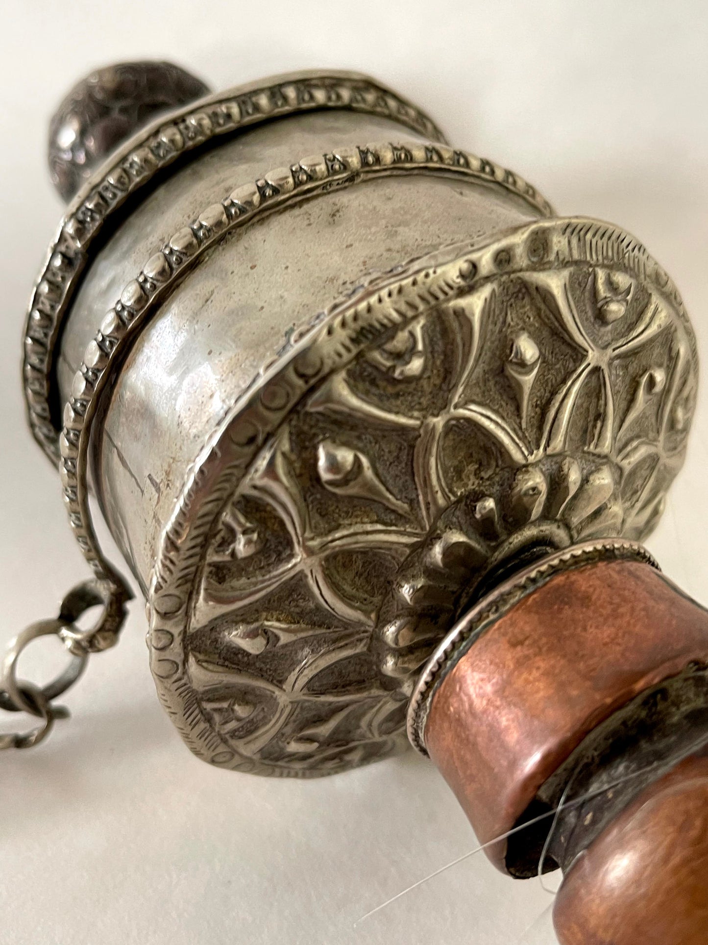 An original handmade vintage Tibetan silver handheld prayer wheel simply carved and decorated