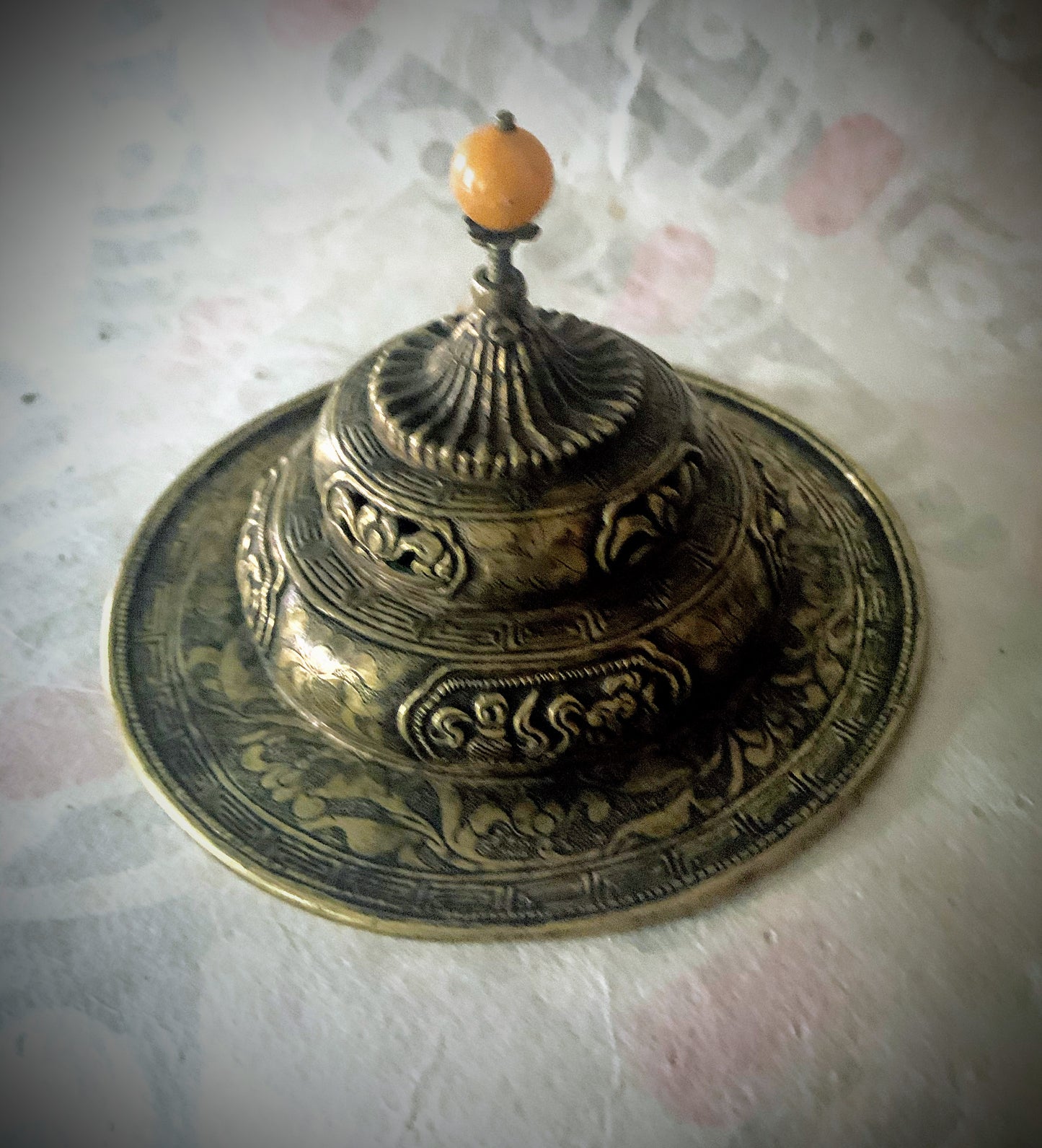 An antique metal cup stand