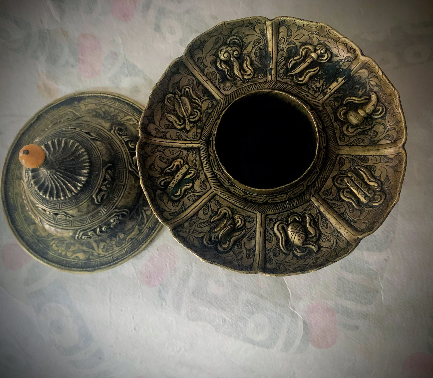 An antique metal cup stand