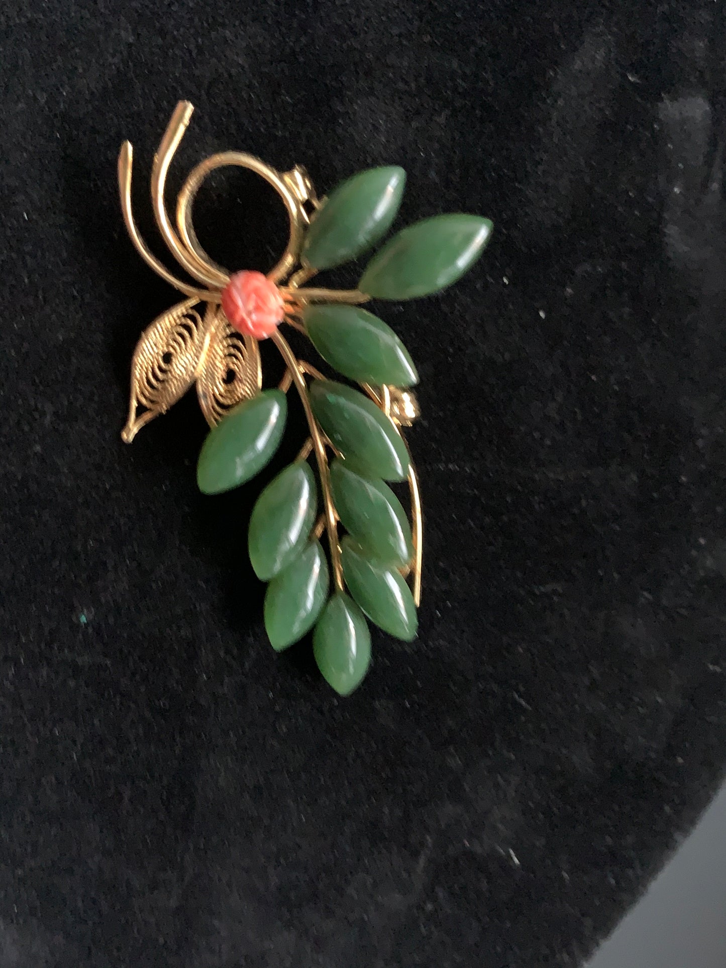 A jade and coral brooch
