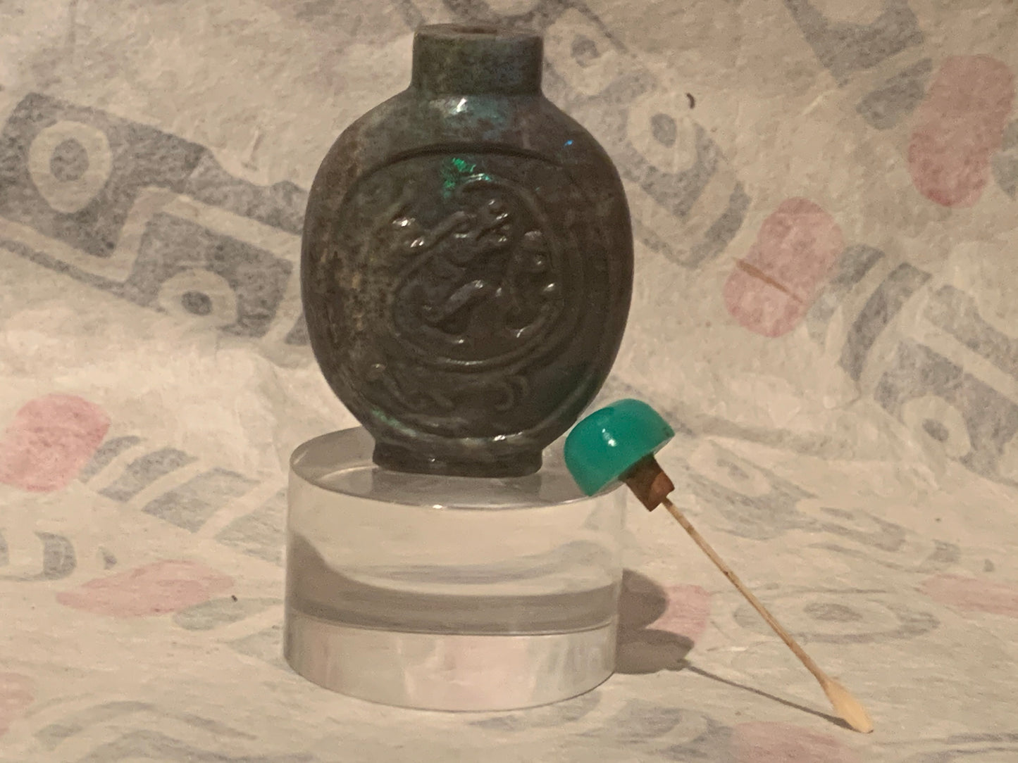 A carved opal snuff bottle with a jade stopper