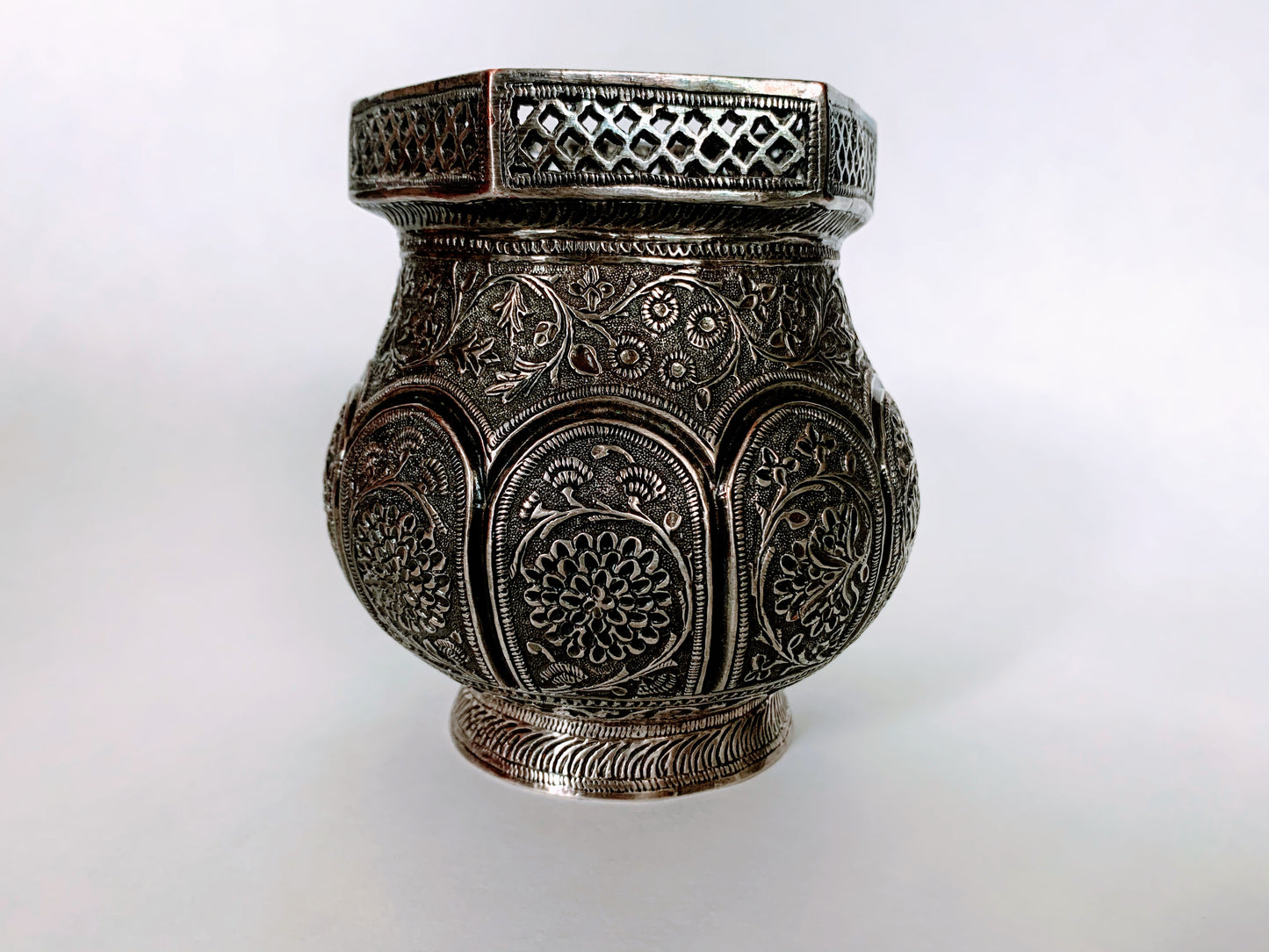 An exquisitely carved antique silver utensil -possibly a censer with floral details
