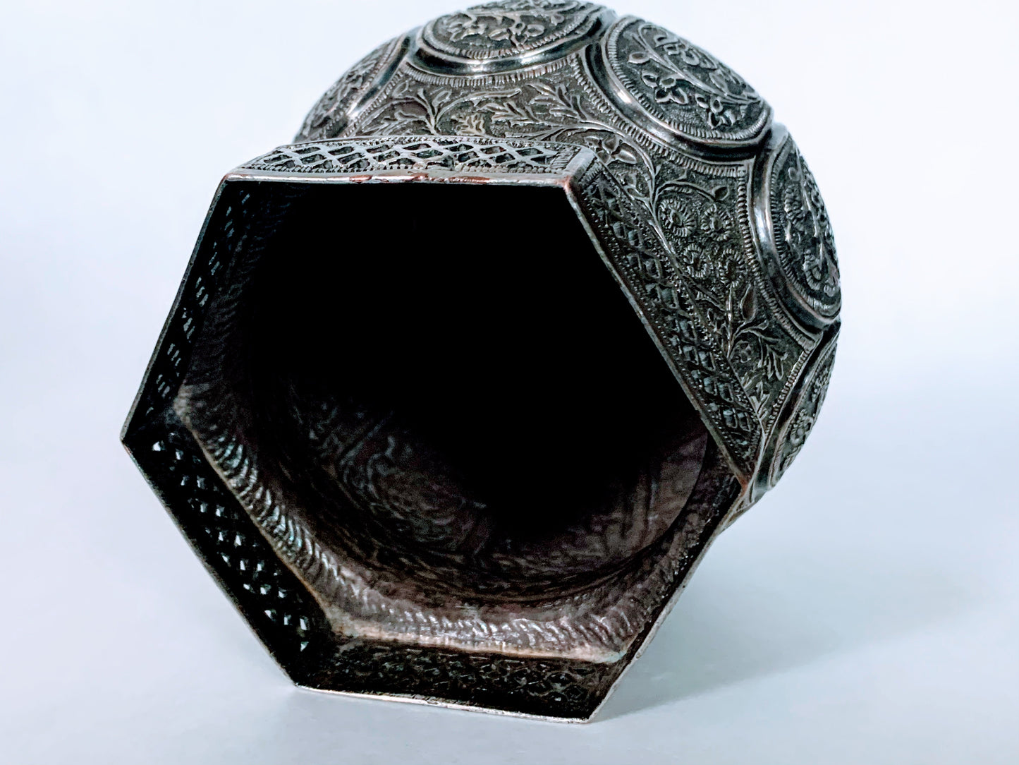 An exquisitely carved antique silver utensil -possibly a censer with floral details