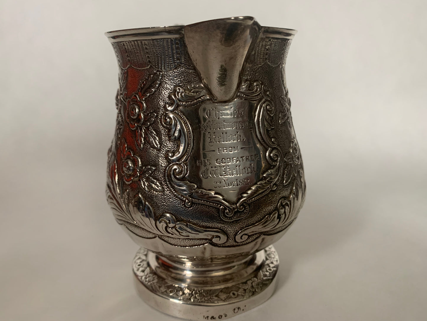 A silver creamer (roses)