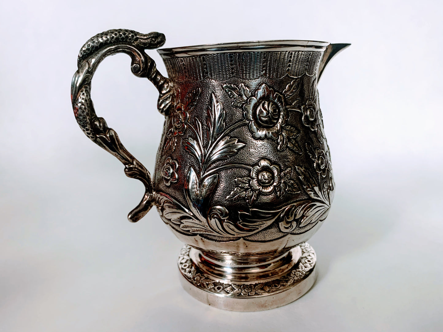A silver creamer (roses)