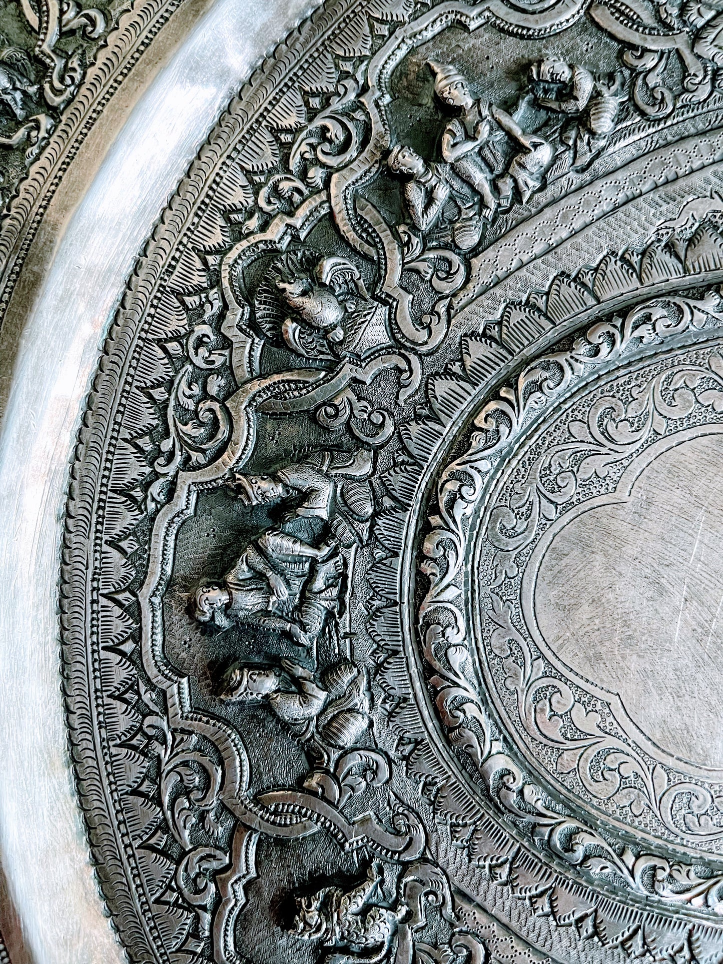 A Burmese antique elaborately carved circular tray and oval shaped jug with a pointed mug.