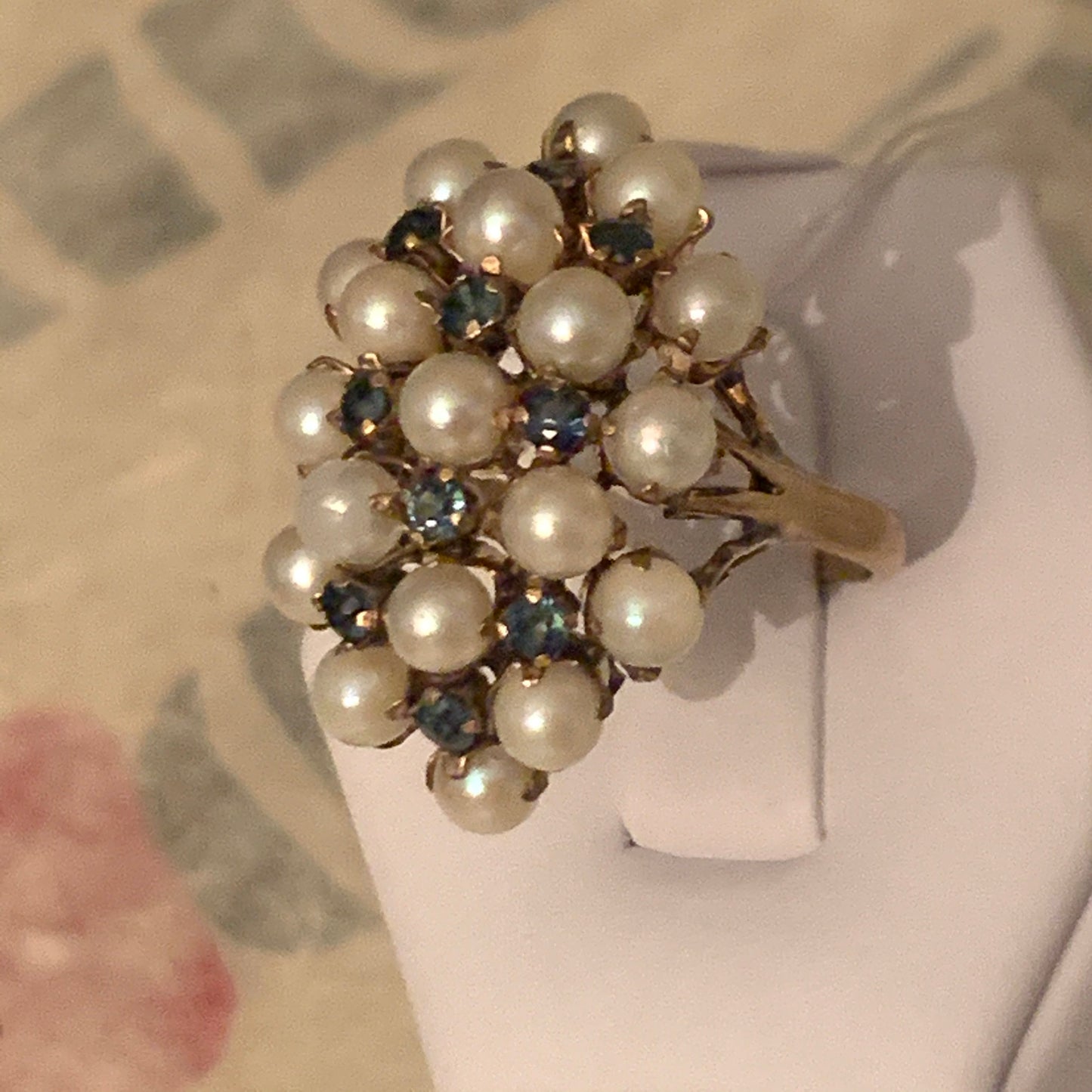 A pearl and sapphire ring in a 14kt setting