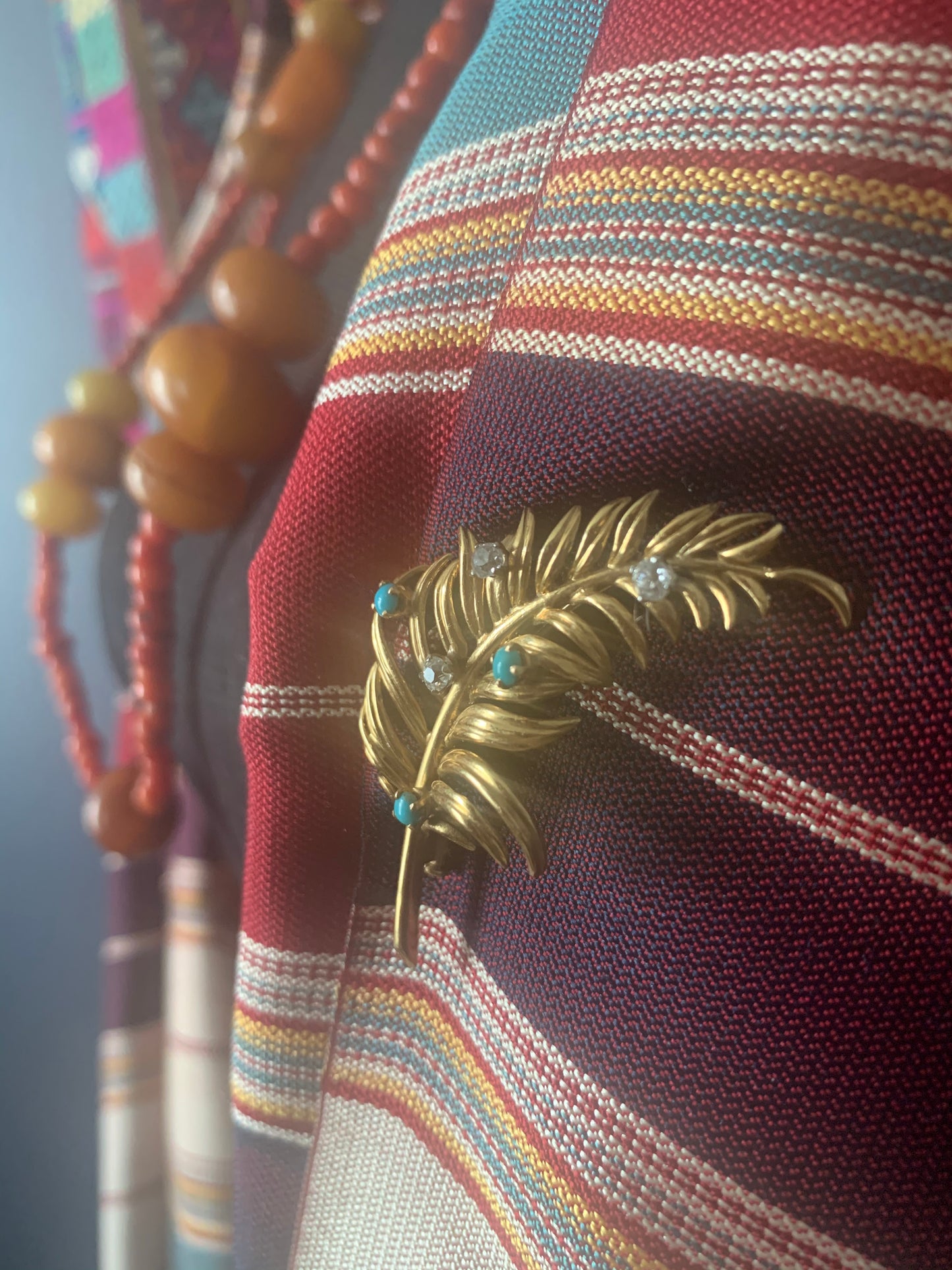 A 18kt gold brooch with turquoise and diamonds.