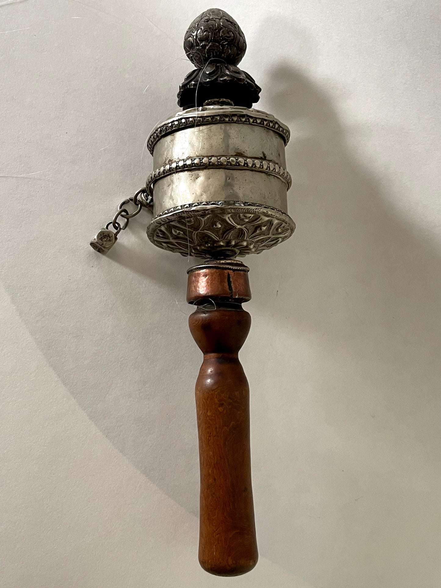 An original handmade vintage Tibetan silver handheld prayer wheel simply carved and decorated