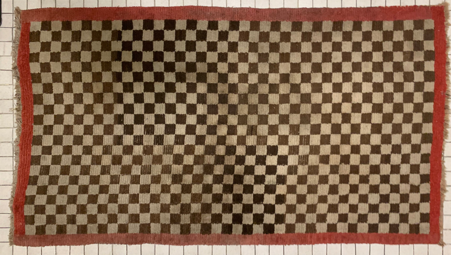 An antique Tibetan checkerboard rug